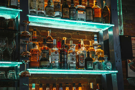 Photo by Diane Picchiottino on Unsplash of rum bottles in a New York bar