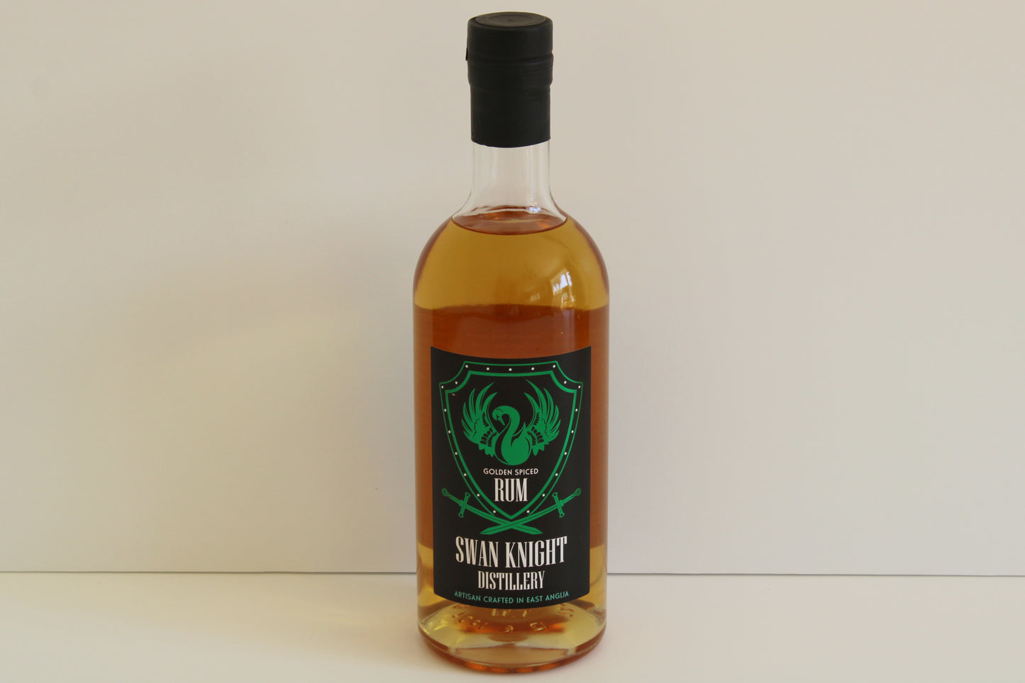 Single bottle of Swan Knight Distillery golden spiced rum on a white background